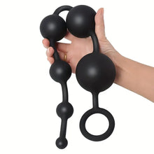 Load image into Gallery viewer, 50cm black anal pulling beads sex toy being held in a mans hand.