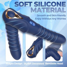 Load image into Gallery viewer, A black rippled dual vibrator with anal and vaginal shafts and a gold button to operate on a pastel blue background.